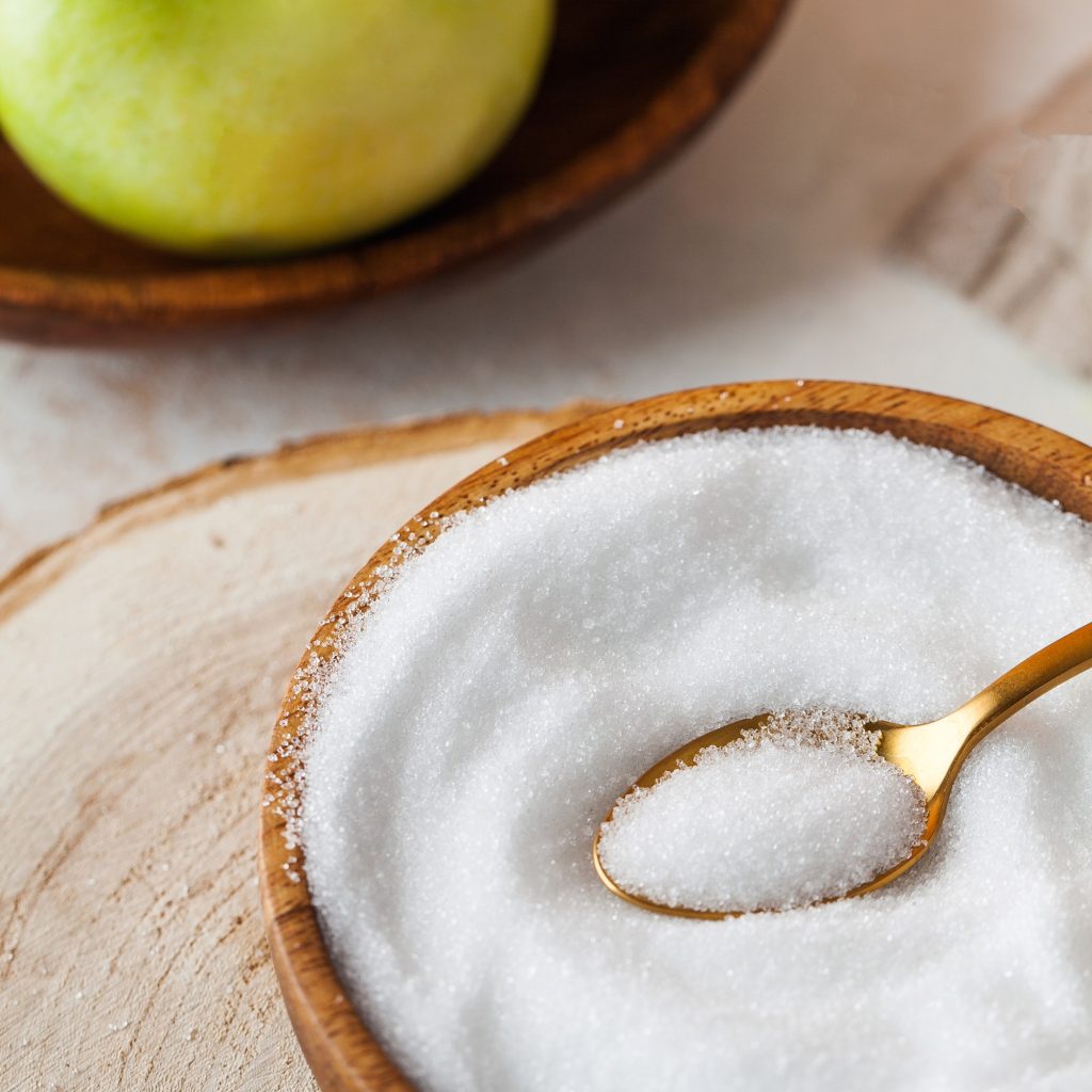 Natural sweetener in a wooden bowl. Erythritol