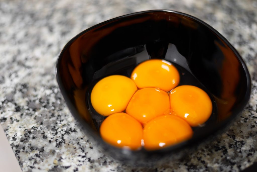 Egg yolks on a black bowl