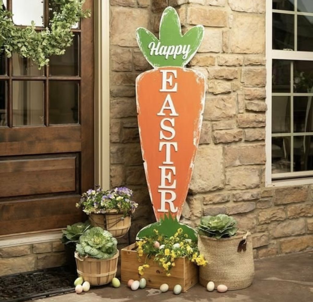 a greeting easter carrot with easter eggs and flowers