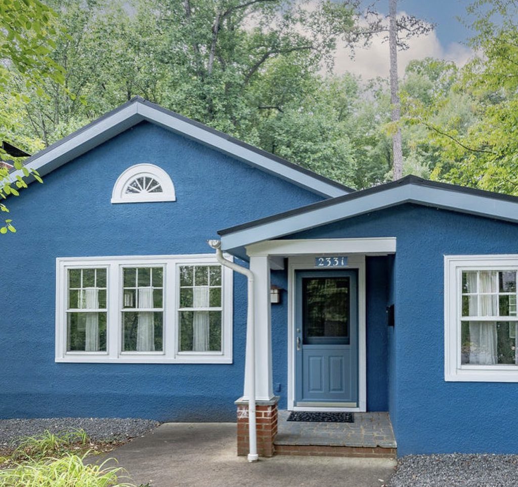 A light blue front door with a white frame