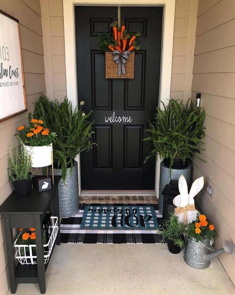 a skillful play of spring greens, flowers, a wreath with carrots and an easter themed doormat