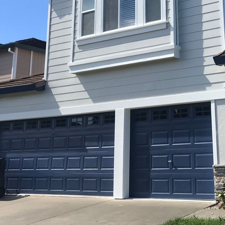 a cloudy navy blue garage door 