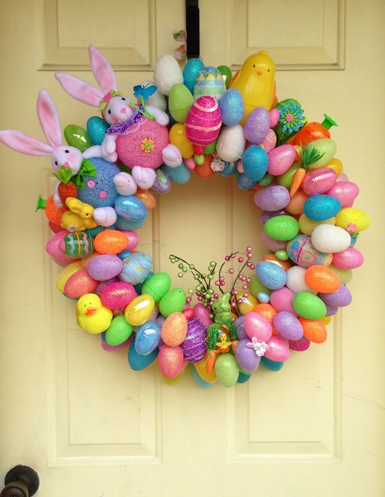 a wreath made of colorful easter eggs and easter bunnies