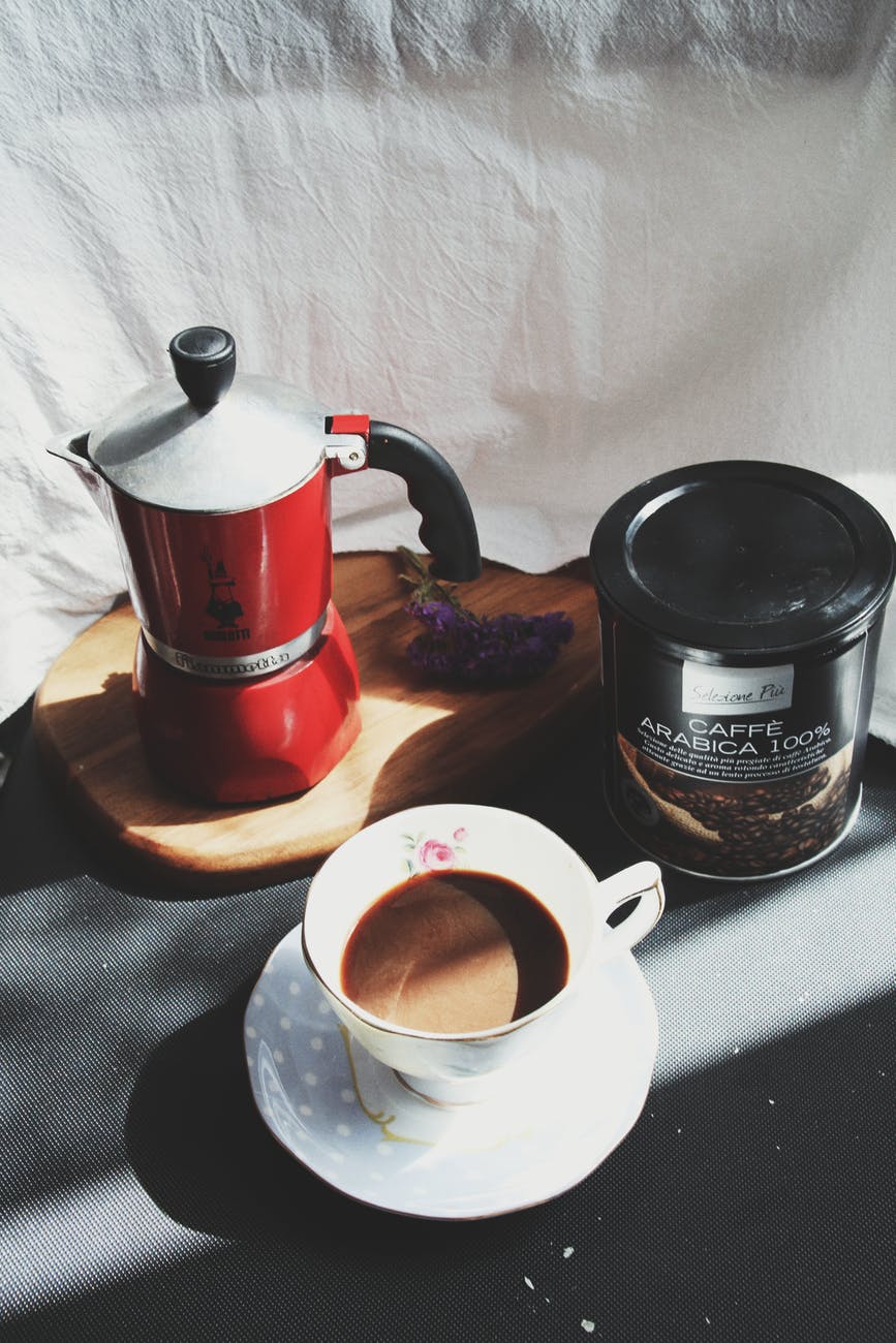 white cup with coffee inside