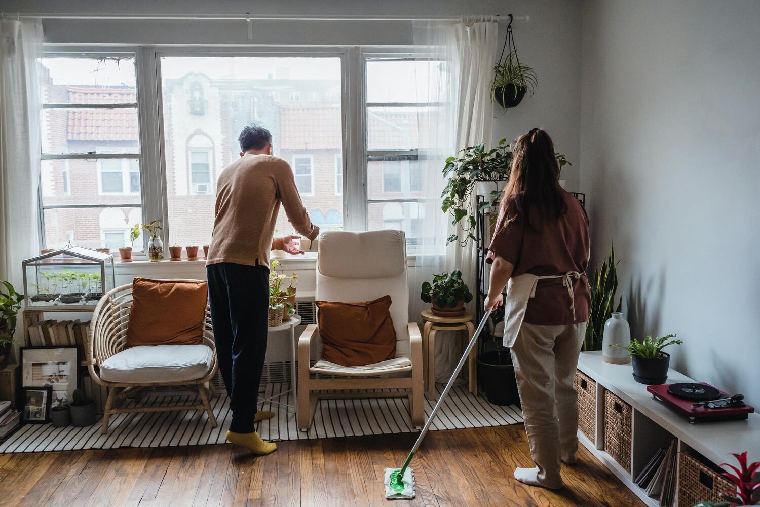 Couple cleaning their living room